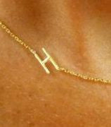 The closeup view shows the fine detail and craftsmanship of our sideways initial necklace in gold. We have the original at I Love Jewelry Auctions!