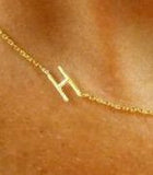 The closeup view shows the fine detail and craftsmanship of our sideways initial necklace in gold. We have the original at I Love Jewelry Auctions!